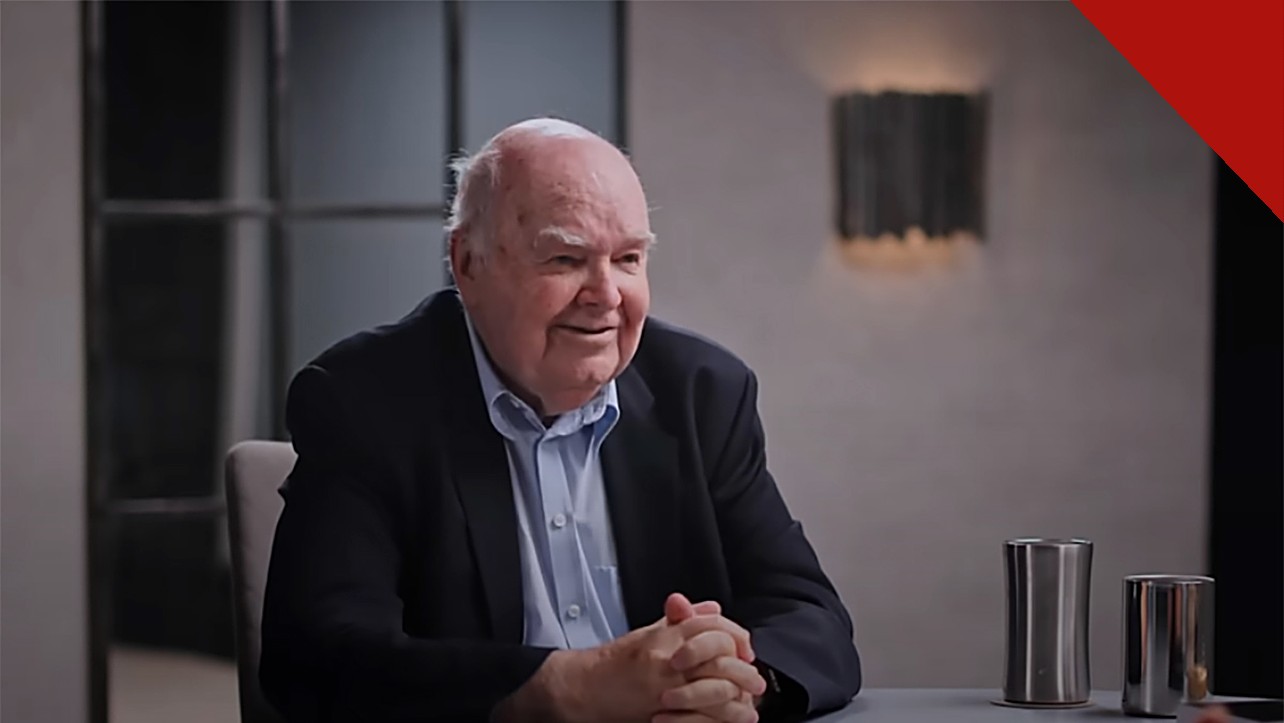 John Lennox exorta cristãos a evangelizar: o matemático de Oxford, de terno escuro e mãos entrelaçadas, conversa durante entrevista