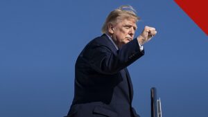 Trump vota antecipado na Flórida: Donald Trump de terno escuro apontando ao desembarcar de aeronave oficial, em foto de outubro de 2026