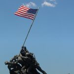 ataque ao memorial de Iwo Jima: estátua do Marine Corps War Memorial com fuzileiros hasteando a bandeira dos Estados Unidos sob céu azul