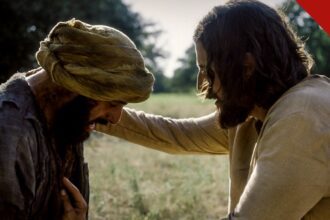 The Chosen sexta temporada: cena da série em que Jesus, interpretado por Jonathan Roumie, toca um leproso em campo aberto