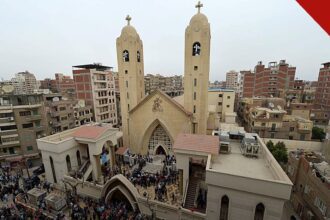 cristão copta é detido no Egito é o caso de Sherif Wagih Fahmi, e a imagem mostra uma igreja copta com torres em cidade do Egito, cercada por fiéis