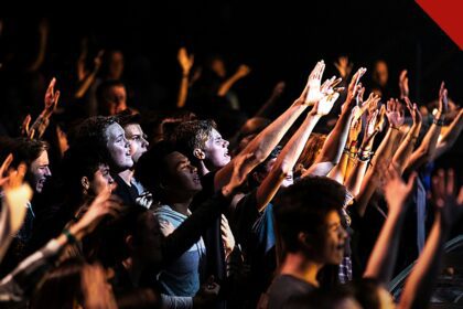 jovens adultos frequentam cultos mais que os pais, e a imagem mostra jovens em um culto nos Estados Unidos durante um momento de adoração
