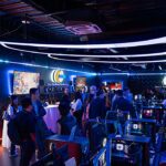 youtuber Dedeco morre aos 33 anos, e a imagem mostra um espaço gamer com computadores, telas acesas e cadeiras de jogos, em foto de arquivo