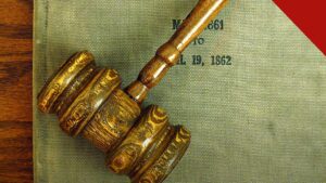 Empresas fecham acordo por discriminação religiosa: martelo de juiz sobre livro de tribunal nos Estados Unidos