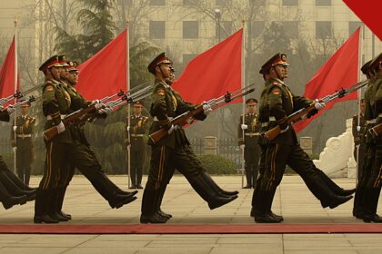 China anuncia nova purga de generais e oficiais por corrupção em comunicado divulgado na quinta-feira, e a imagem mostra soldados da guarda de honra chinesa em formação com bandeiras vermelhas, em foto de arquivo