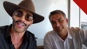Gusttavo Lima declara apoio a Flávio: o cantor, de chapéu e óculos escuros, ao lado de Flávio Bolsonaro no vídeo gravado na casa do artista