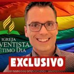 Pastor diante da bandeira LGBT com o logo da Igreja Adventista do Sétimo Dia, capa exclusiva do Hugo Gospel